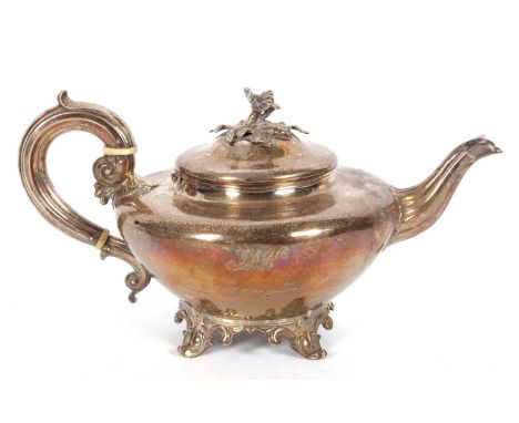 A William IV silver teapot of compressed circular plain form having a cast floral and leaf finial, plain body engraved with i