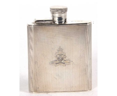 A George VI silver spirit flask, engine turned decorated, the front engraved with The Royal Artillery crest, the top with lan