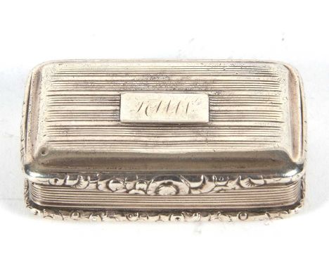 A George IV silver snuff box of rectangular form having cast foliate edges and thumb piece, engraved linear lid and sides,  h