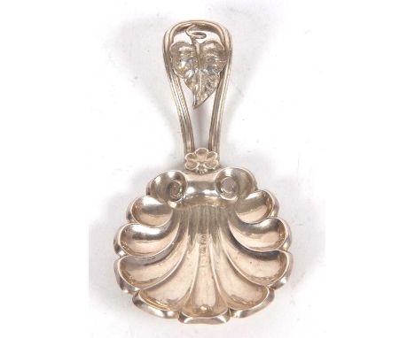 A Victorian silver caddy spoon with a large shell bowl vine leaf pierced handle, hallmarked for Birmingham 1859, makers mark 