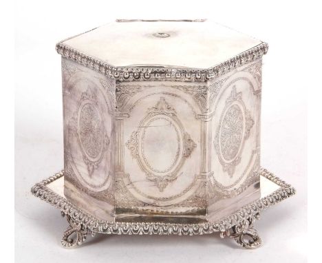 An early 19th Century silver plated biscuit barrel of hexagonal form on integral gadrooned decorated base, supported of four 
