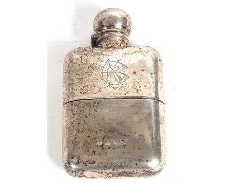 A late Victorian silver spirit flask, the front with a monogram, the verso engraved with a Griffin and script, with a bulbous