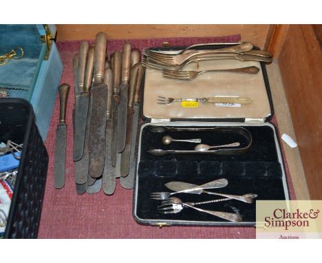 A collection of cutlery to include Christoffel forks, a pickle fork a pair of silver sugar tongs, a silver cruet spoon, butte