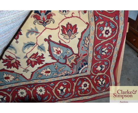 An approximate  9'3" x 6'6" red floral patterned carpet