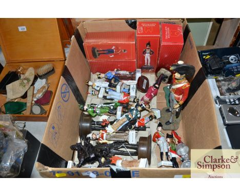 A box containing various solider ornaments and figures