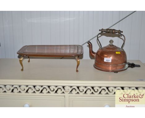 An electric copper kettle - sold as collector's item; and a copper warming tray also sold as collector's item