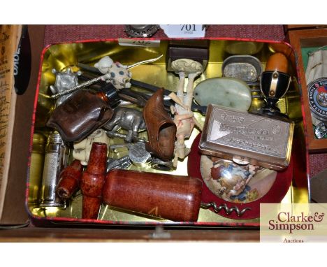 A tin containing a corkscrew; carved wooden shoe; carved animal ornaments; tuning forks; jade type pendant etc