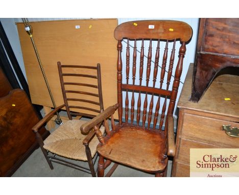 A rocking chair together with a ladder back armchair
