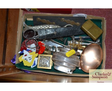 A box containing Art Deco style brooches; a bottle opener in the form of a fish; Zippo lighter; yellow metal chain etc