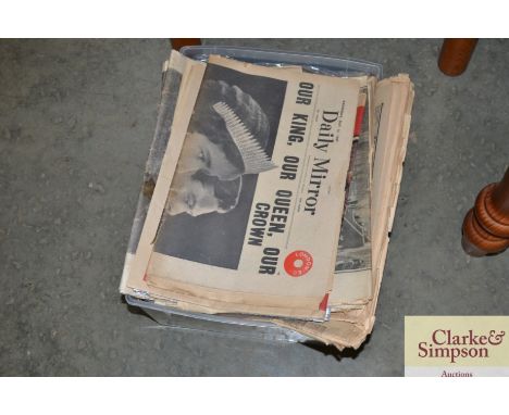 A box containing various vintage newspapers