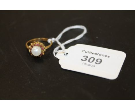 A RUBY? AND PEARL DRESS RING STAMPED 750 APPROX 5.2G