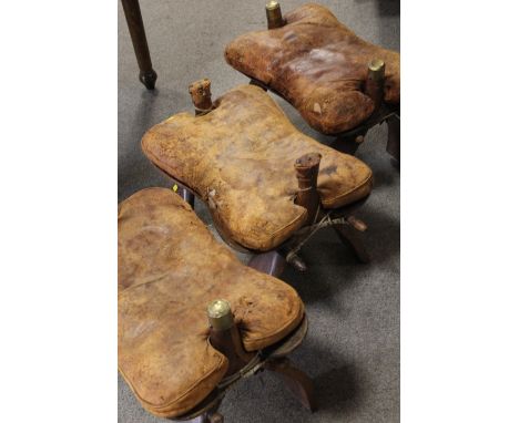 THREE VINTAGE CAMEL SADDLE STOOLS 