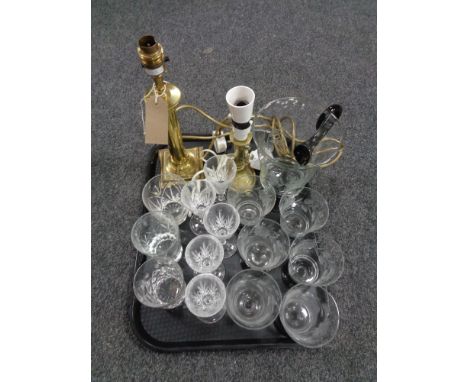 A tray of brass candlestick table lamp and one further, brass lamp, etched glass water jug and drinking glasses 