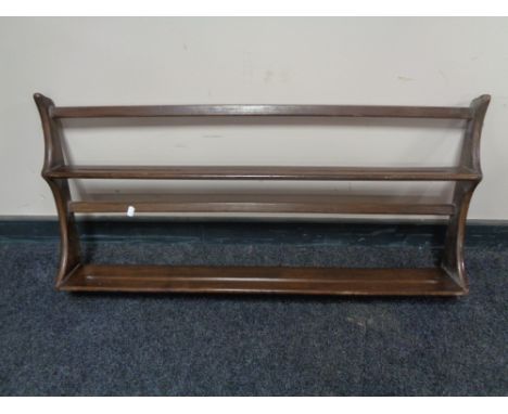 An Ercol wall shelf, width 97 cm, height 50 cm.