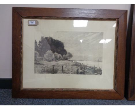An early twentieth century monochrome print depicting marshland in an oak frame