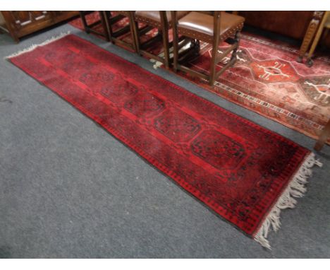 An Afghan Bokhara runner, 302cm by 80cm