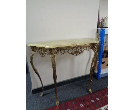 A shaped ornate onyx console table on brass legs, height 78 cm, depth 35 cm, width 103 cm. CONDITION REPORT: This is in good 