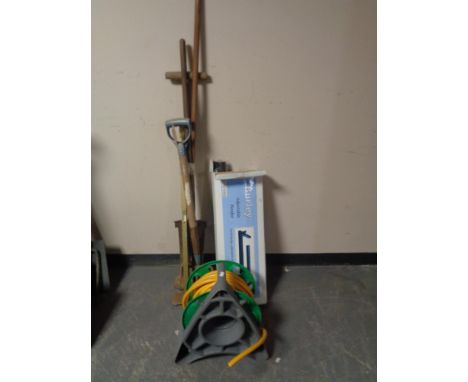 A bundle of garden tools together with a hose pipe on reel and a boxed adjustable fender 