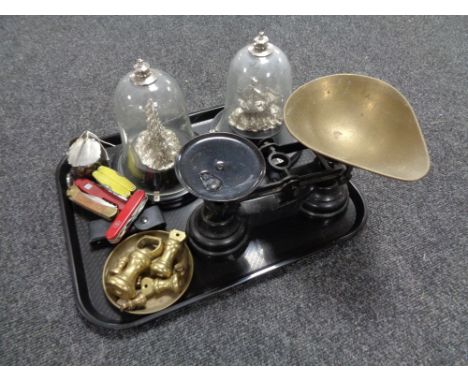 A tray of kitchen scales and weights, pocket knives including Leatherman, white metal ship's under glass bell domes 