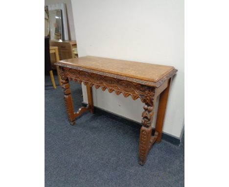 An Edwardian carved oak console table 