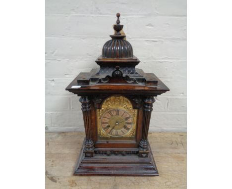 An Edwardian stained pine bracket clock with brass and silvered dial 