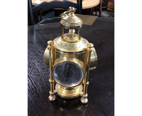 A decorative brass triple aspect lantern clock/barometer/biometric pressure monitor also fitted with a compass 