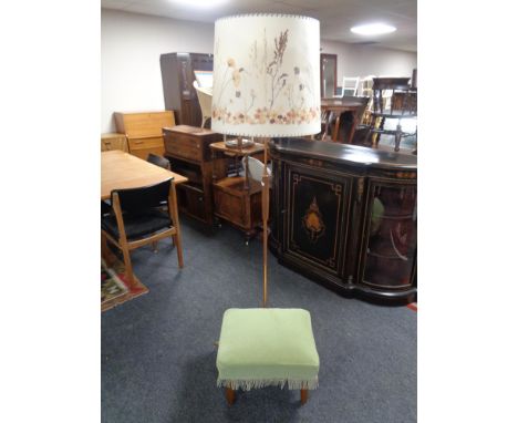 A 1970's copper and teak standard lamp with shade together with a green dralon upholstered stool on teak legs 