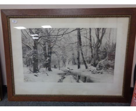 An early twentieth century monochrome print depicting a continental winter woodland 