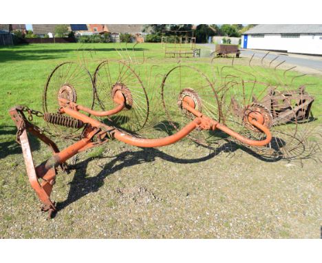 Tractor mounted hay rake