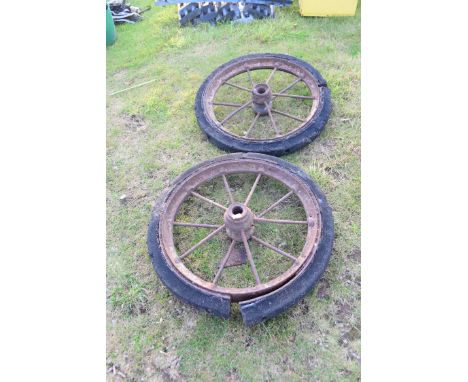 Pair of vintage iron ten spoke wheels with solid rubber tyres, wheels approx 78cm diam ex tyres