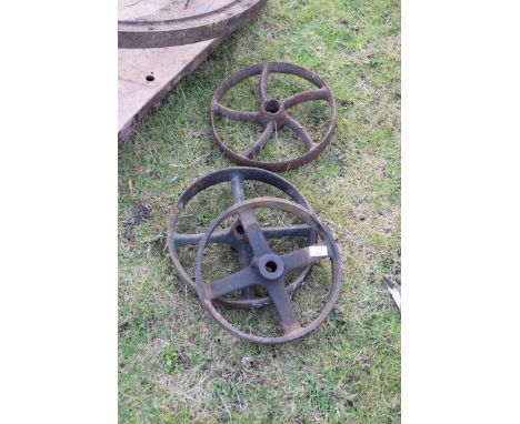 Three vintage implement wheels, largest approx 32cm diam