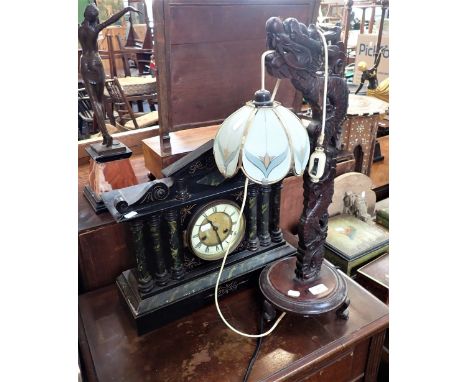 A CHINESE CARVED HARDWOOD TABLE LAMP, an American simulated slate mantel clock and a 1920s oak cased sewing machine