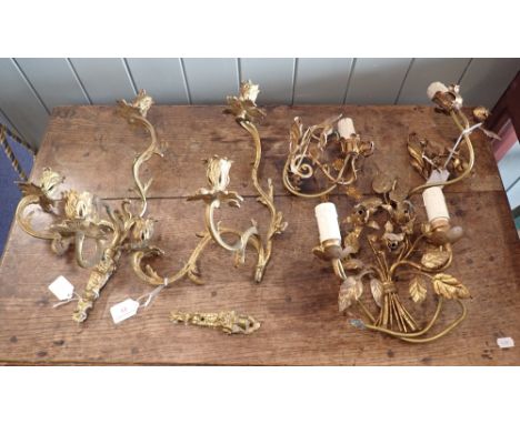 A PAIR OF ROCOCO THREE-BRANCH WALL APPLIQUES and a set of three pressed metal foliate wall light fittings