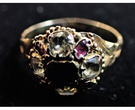 A SAPPIRE, CHRYOBERYL AND GARNET RING, the central rectangular cut sapphire within a surround of cushion cut chrysoberyl and 