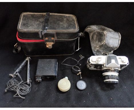 A NIKOMAT CAMERA with outer case and accessories 