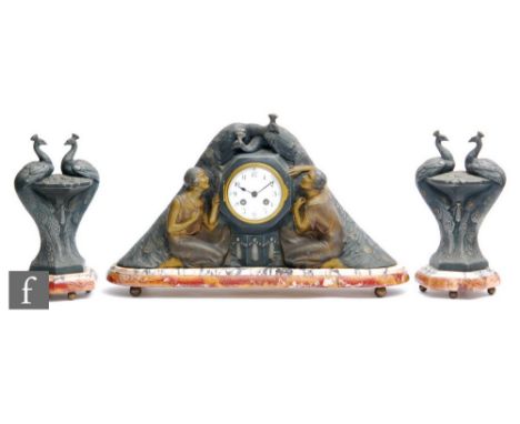 P Sega - A French Art Deco patinated spelter mantle clock, the round gilt dial with Arabic numbers, decorated with embracing 