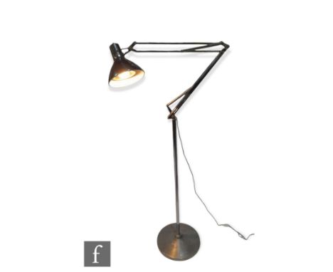 Luxo - A 1970s articulated floor lamp, the brushed aluminium circular base, extending to an adjustable arm and lamp, paper la