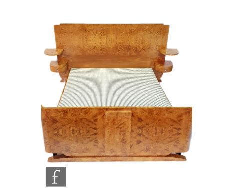 Georges &amp; Gaston Guerin - An Art Deco French burr walnut veneered double bed with an arched head and foot board raised to