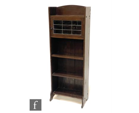 Unknown - An Arts and Crafts oak cabinet bookcase, with galleried shelf above a leaded glazed door and three open fronted boo