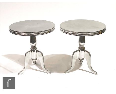 Eichholtz - A pair of 'Nantucket M' polished aluminium side tables, the rounded top on a tripod support, height 60cm, diamete