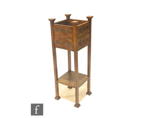 In the manner of Shapland &amp; Petter - An oak jardinière stand of square form, with riveted copper strap work bands above a