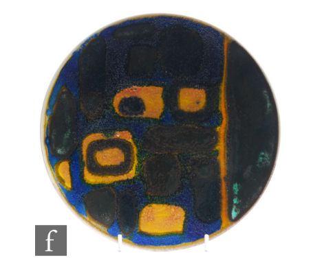 Poole Pottery - A Delphis plate of circular form decorated with ochre and black rectangles over a deep blue textured ground, 