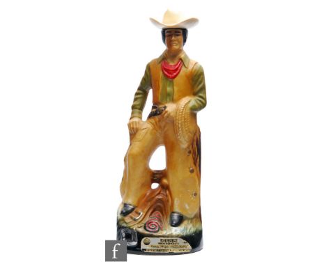 Regal China Corporation - A 1980s Jim Beam ceramic decanter modelled as a cowboy, with plastic cowboy hat lid, retains partia