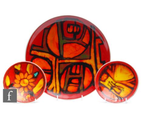 Poole Pottery - A shape 4 Delphis plate, of circular form decorated with an orange and yellow abstract motif over a red groun