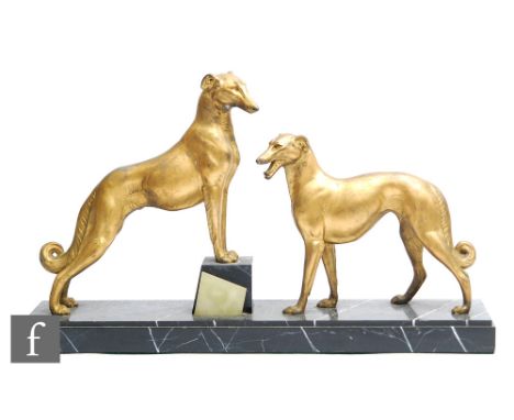 After Louis Albert Carvin - A French Art Deco gilded spelter study of two stylised Borzois, circa 1925, the first front paws 