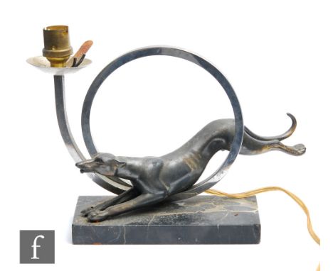 Unknown - An Art Deco table lamp, circa 1930s, decorated with a spelter greyhound jumping through a chrome loop, mounted on a