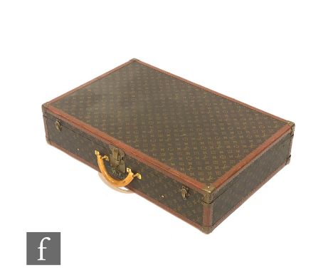 Louis Vuitton - A large Alzer hard case suitcase trunk, monogrammed leather with gold hardware, retains luggage strap and key
