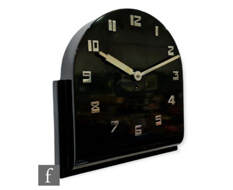 Unknown - An Art Deco hard black lacquered wooden eight day wall clock with stylised chrome Arabic numerals and hands to an a