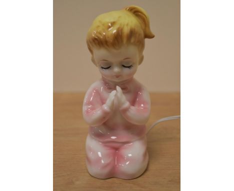 A vintage novelty night light styled as a little girl.