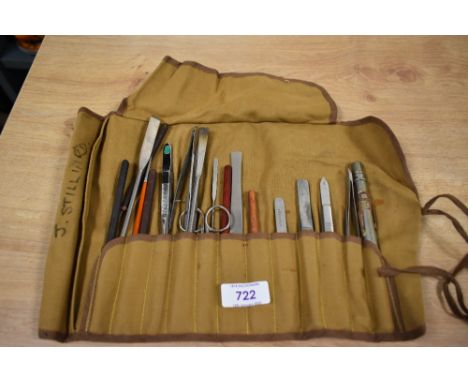 A canvas wrap containing a selection of tools possibly for art or crafting.